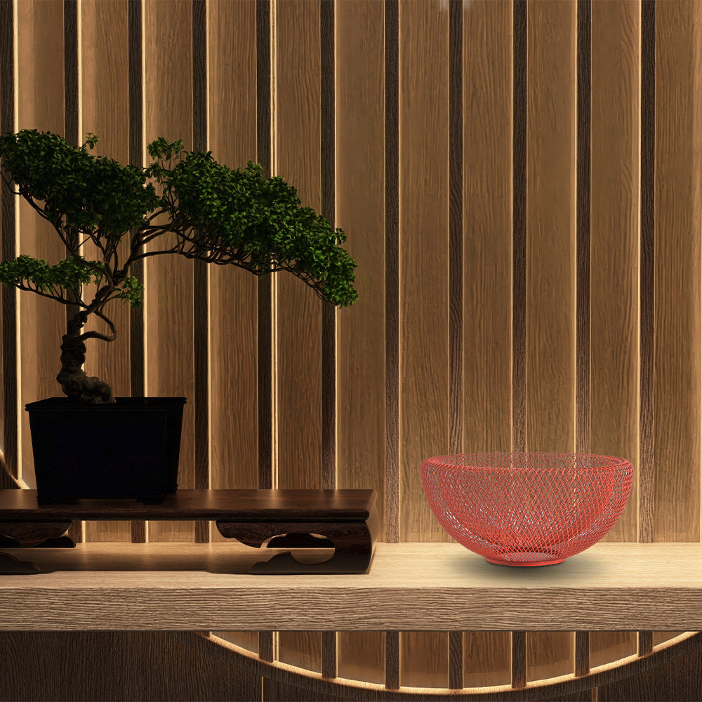Concord Kyoto Series fruit basket Amber color on display on a table next to a Japanese bonsai tree