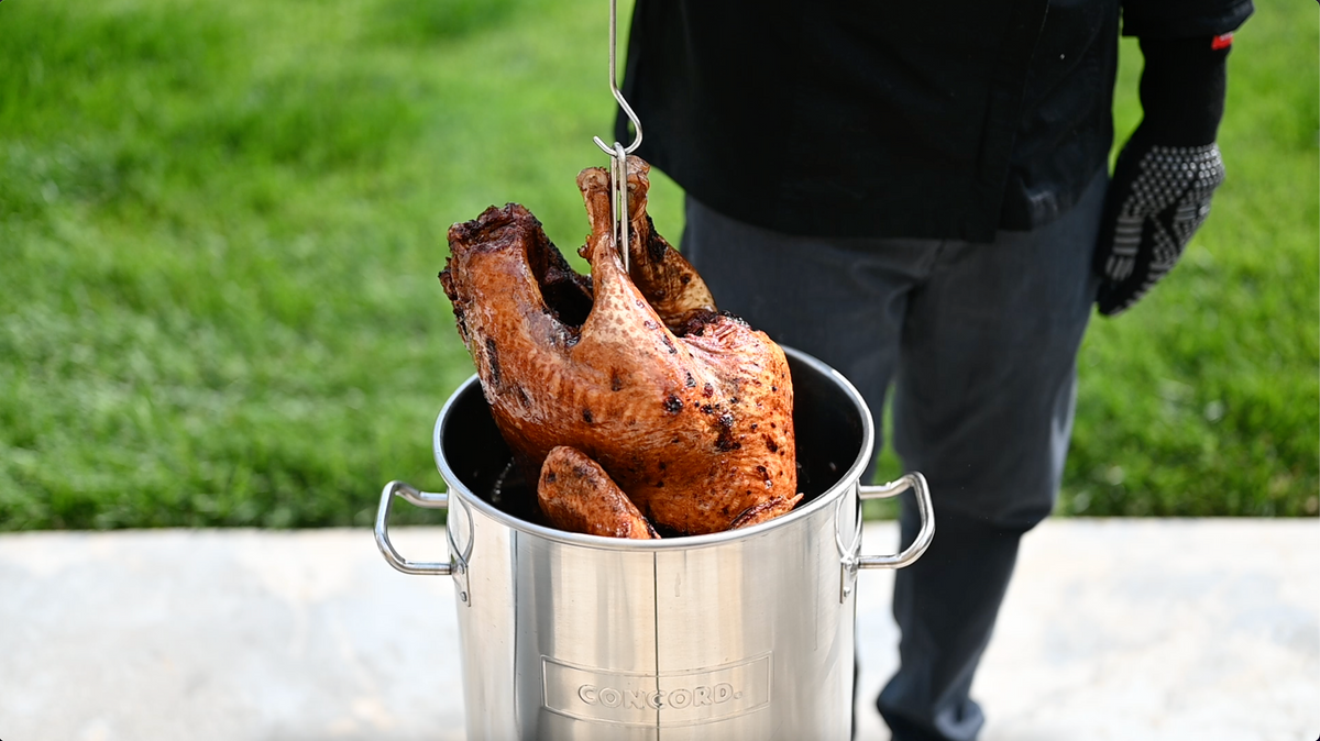 Deep frying a turkey in Concord stainless steel turkey frying pot